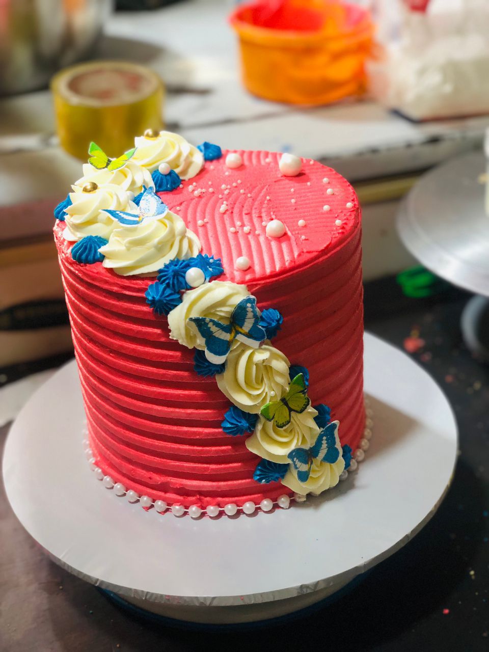 lemon flavoured cakes with red icing and cream topings